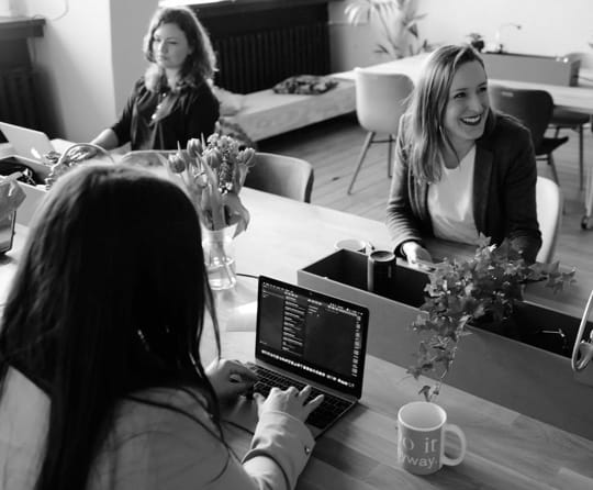 people sitting in front of a laptop